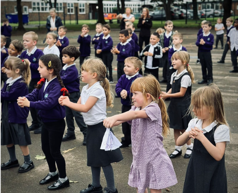 Students dancing on a playground