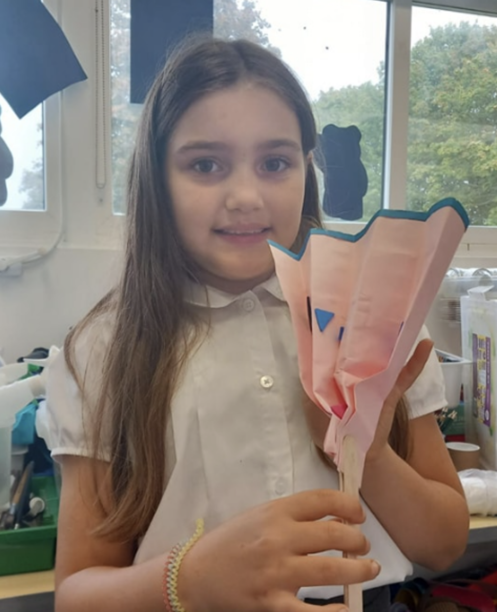 Student holding a fan they made