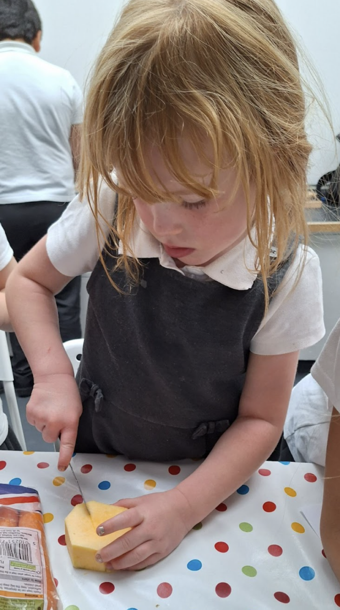 Student cutting a vegetable