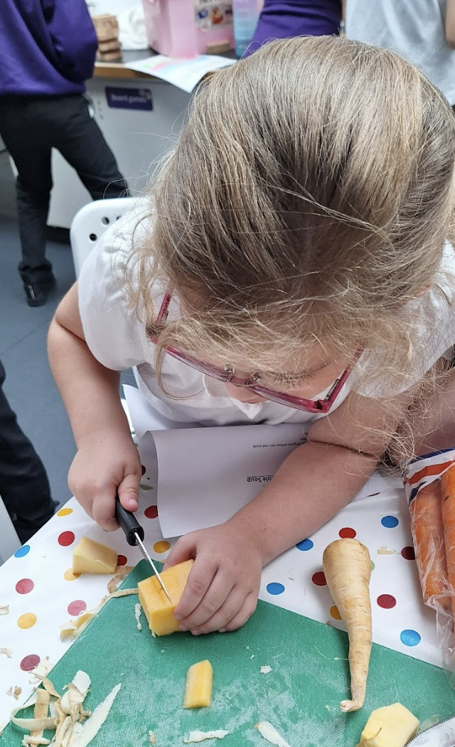 Student cutting a vegetable