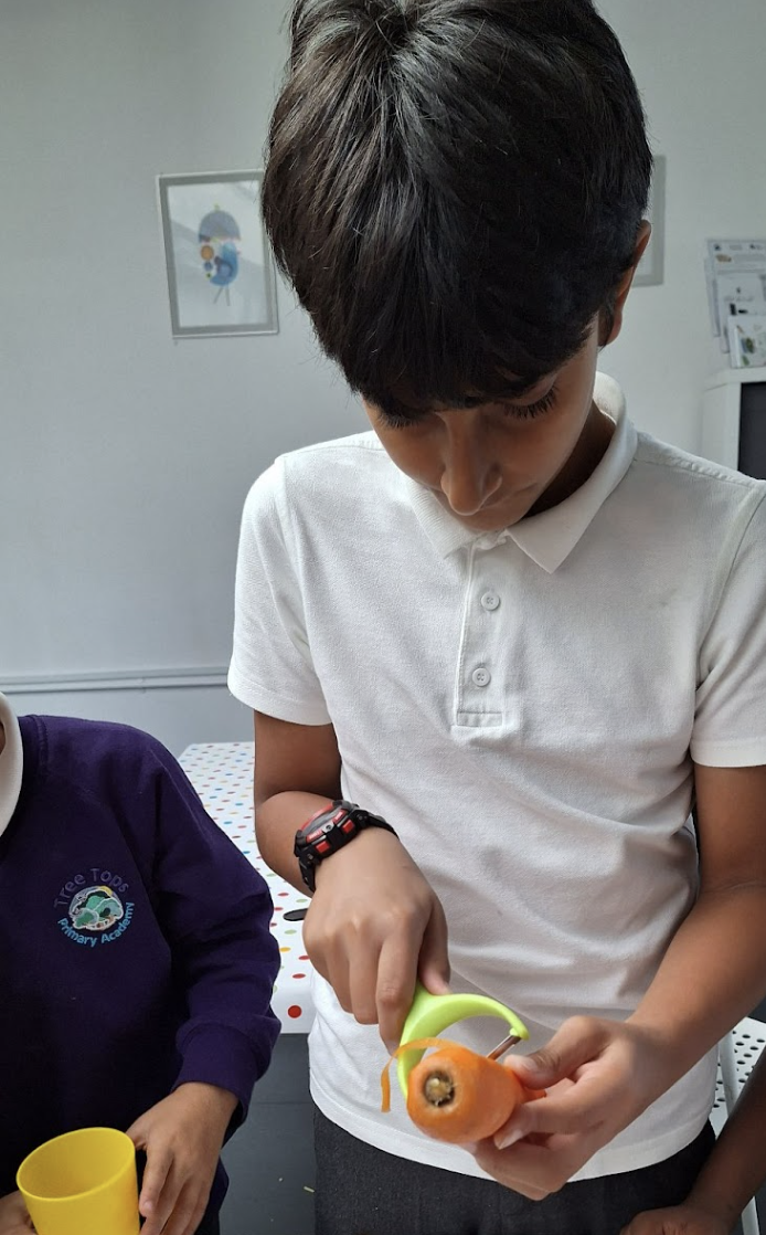 Student peeling a vegetable