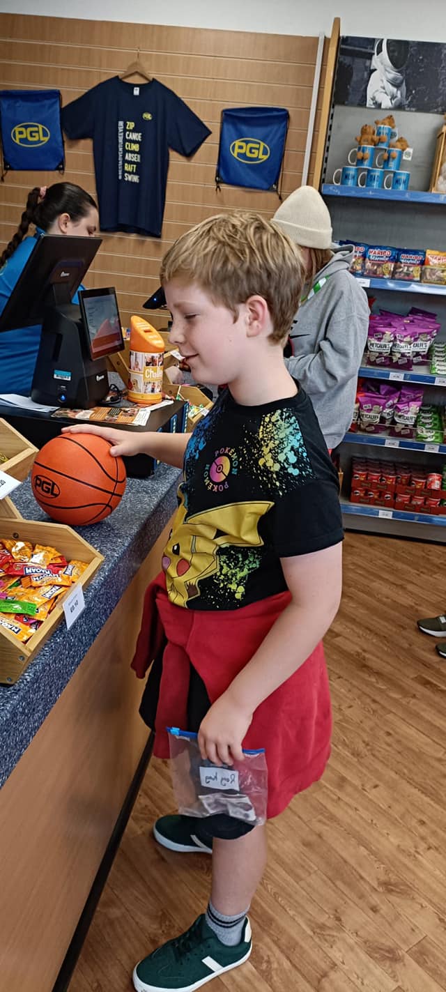 A student in a shop, paying for items