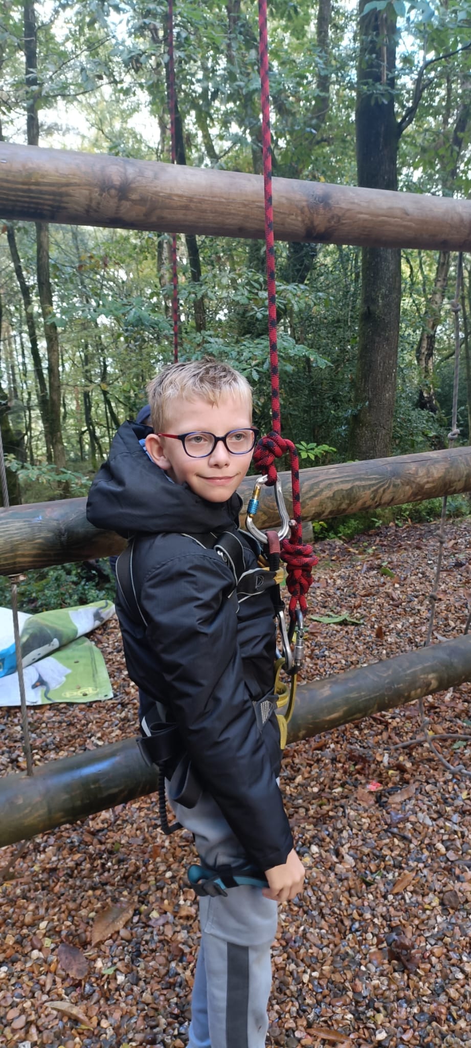 A student in a harness, smiling