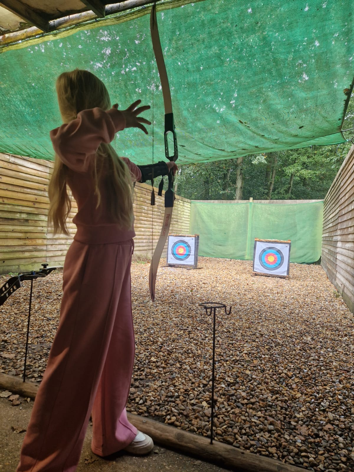 A student shooting a bow and arrow