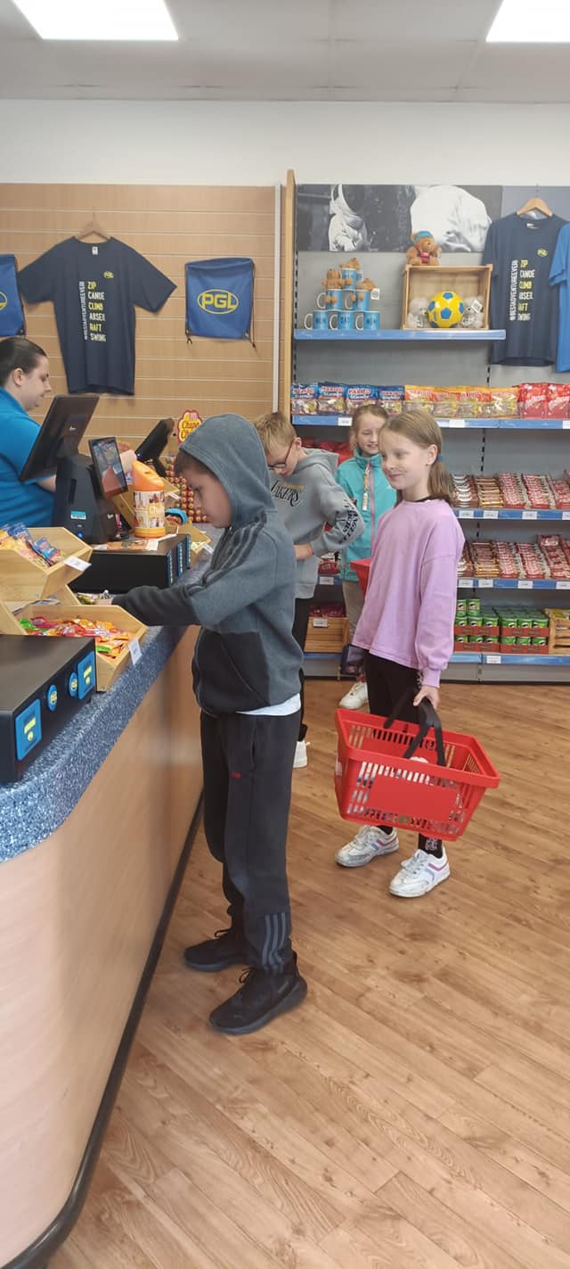 Several students in a shop, paying for items