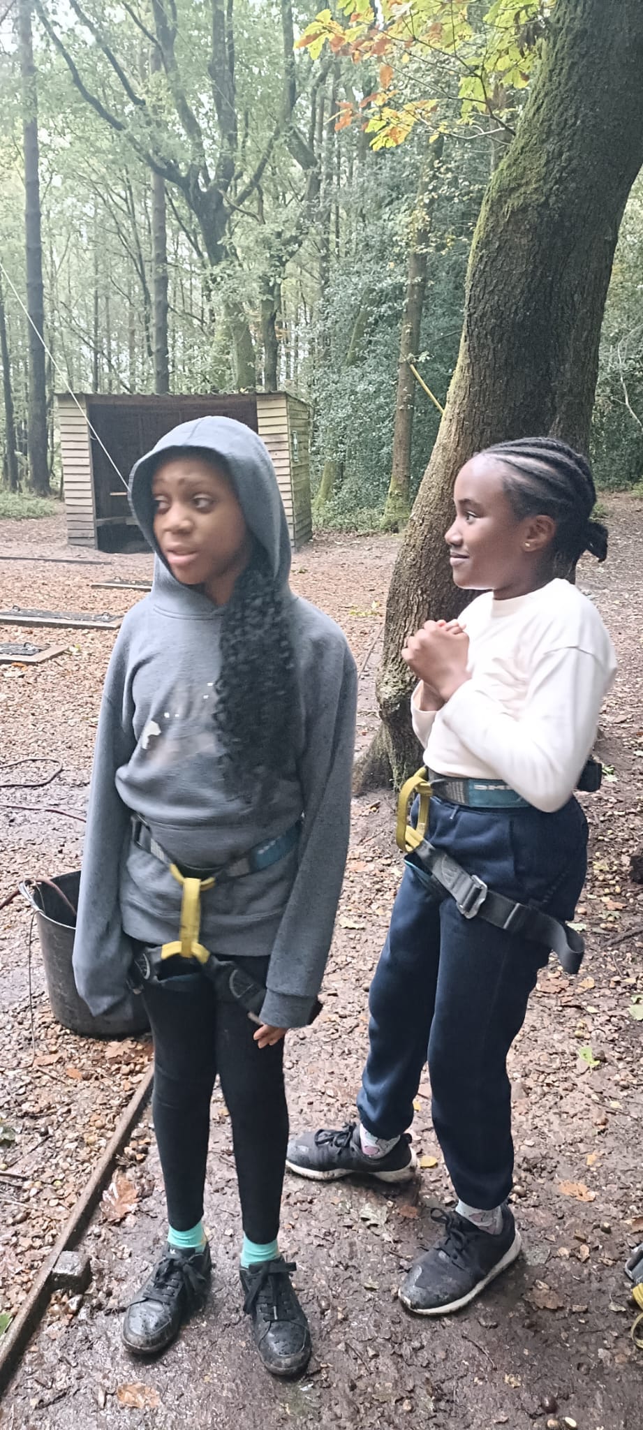 2 students in harnesses, smiling