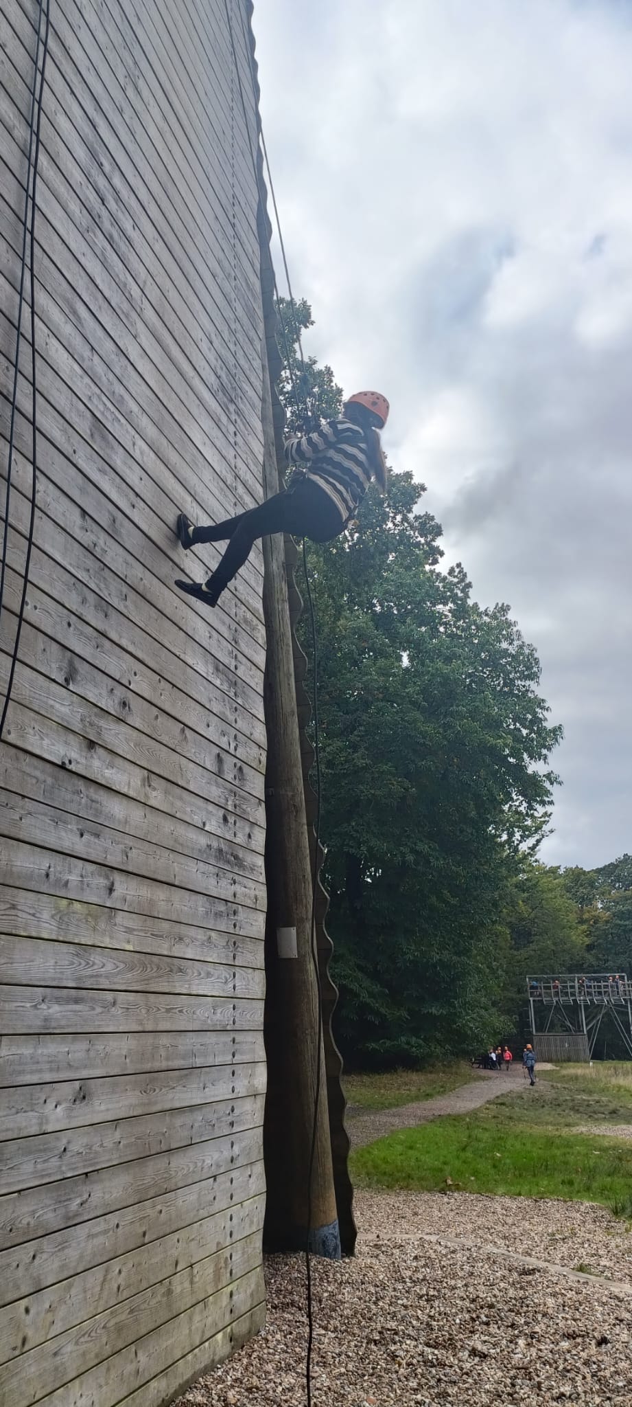 A child abseiling down a wall
