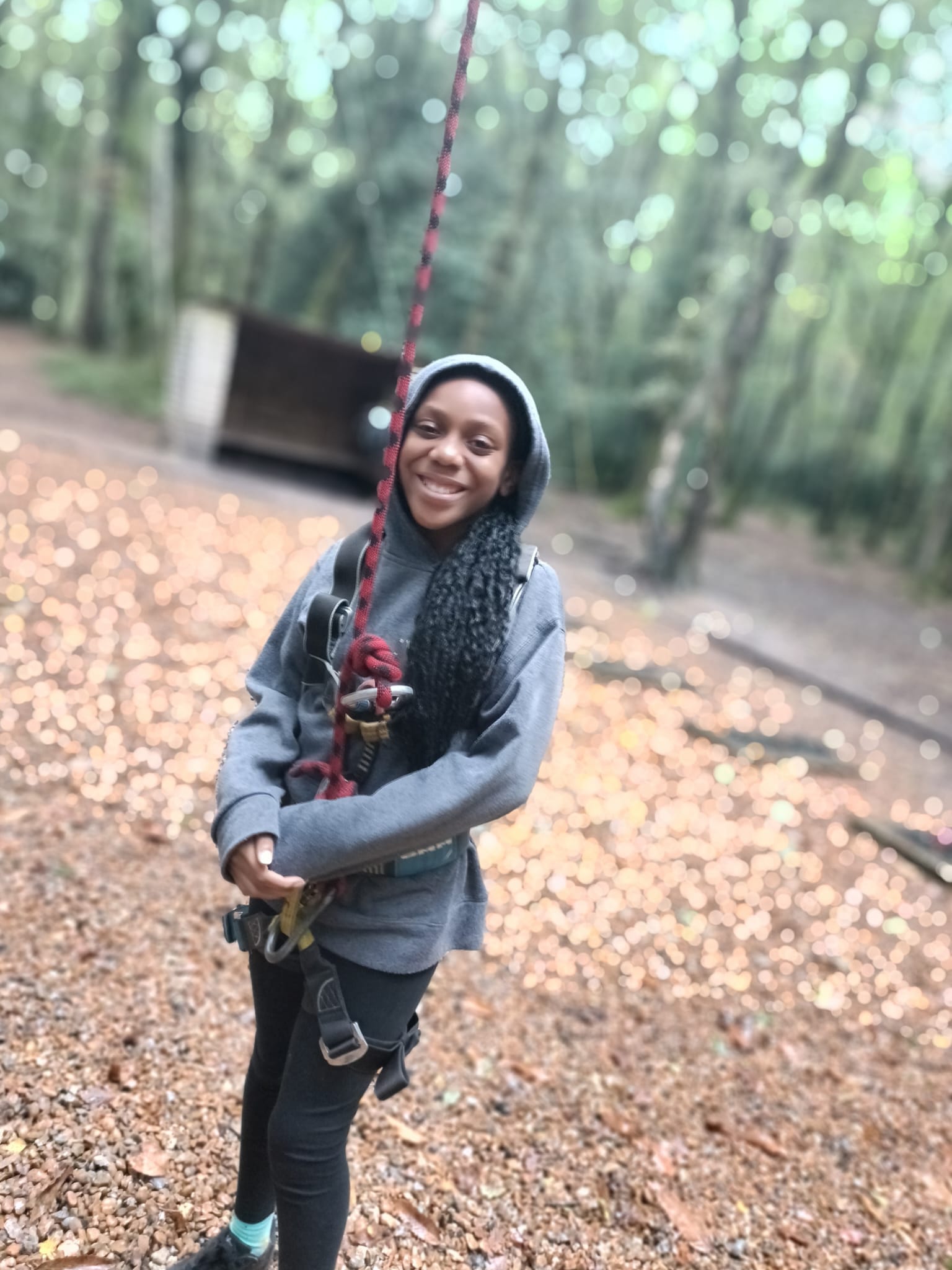 A student in a harness, smiling