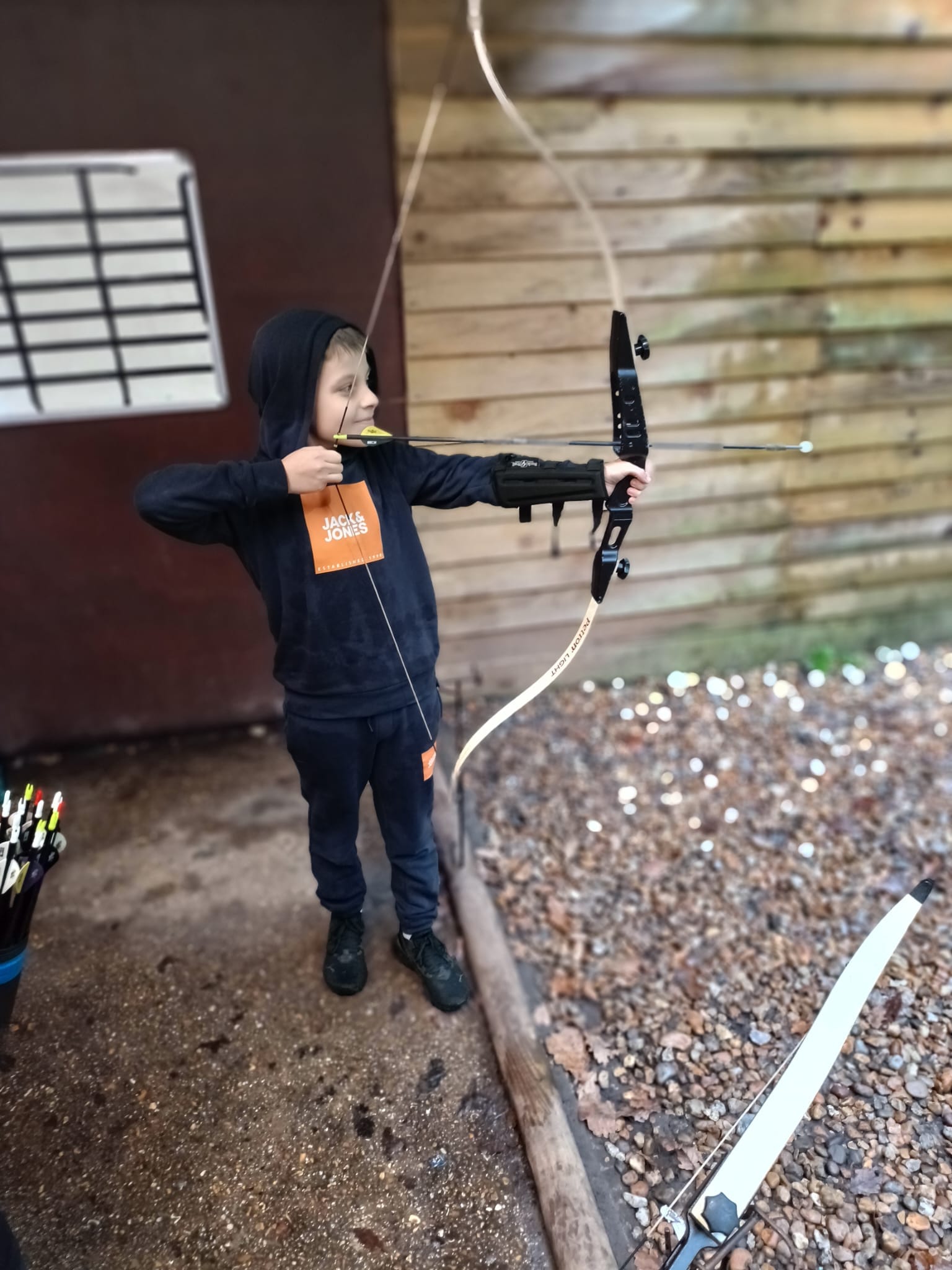 A student shooting a bow and arrow