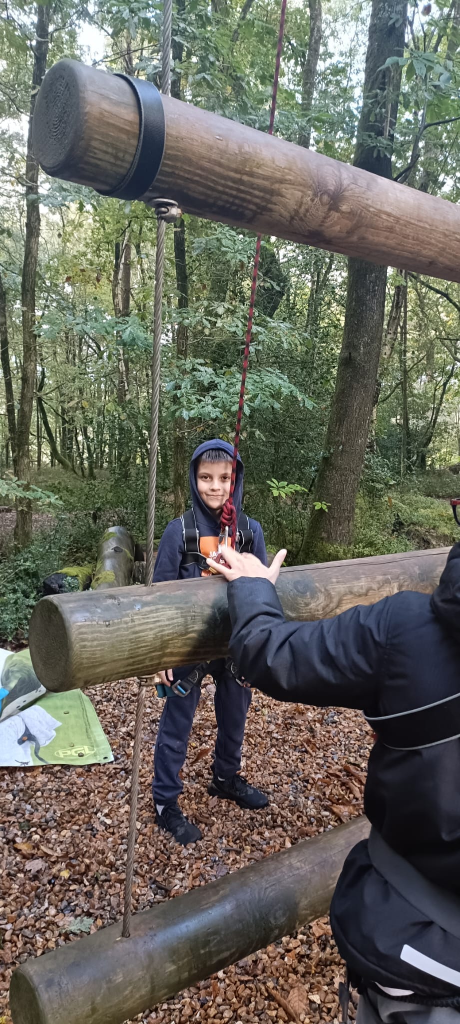 A student in a harness, smiling